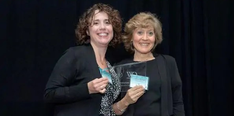 Two women smiling at NVMI.
