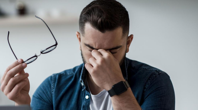 A man with a headache.