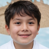 A dark haired child smiling.